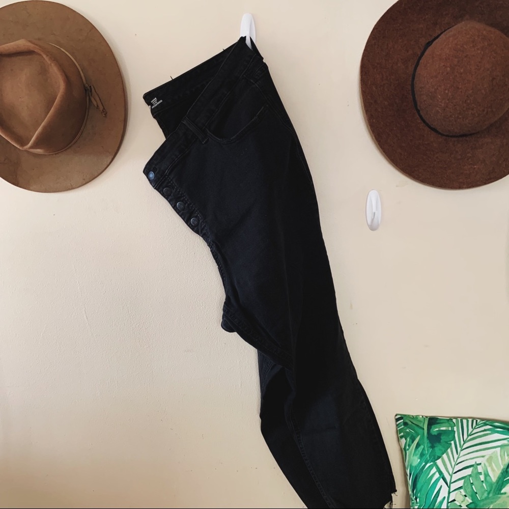 Black button fly skinny jeans